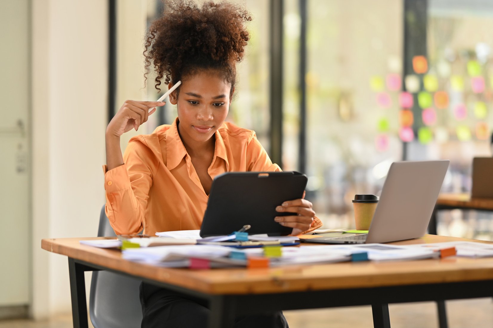 Focused African American female accountant checking online infor