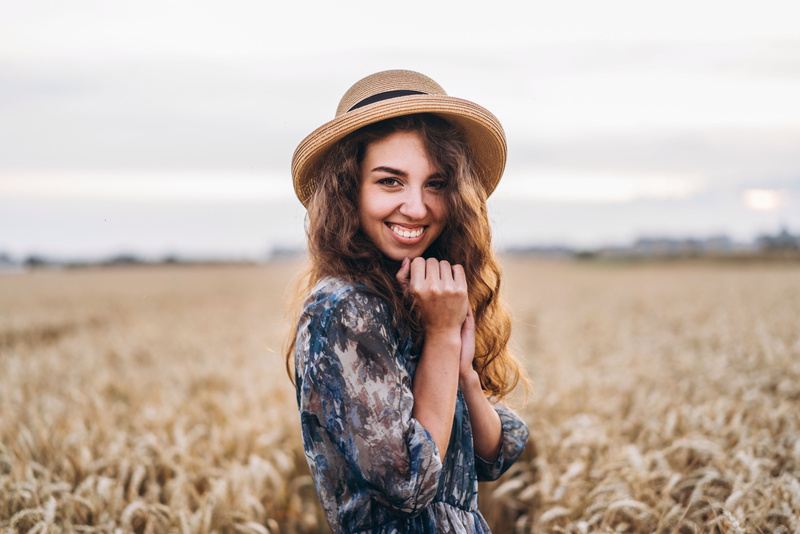 Girl in Floral Dress Posing in a Wheat Field
