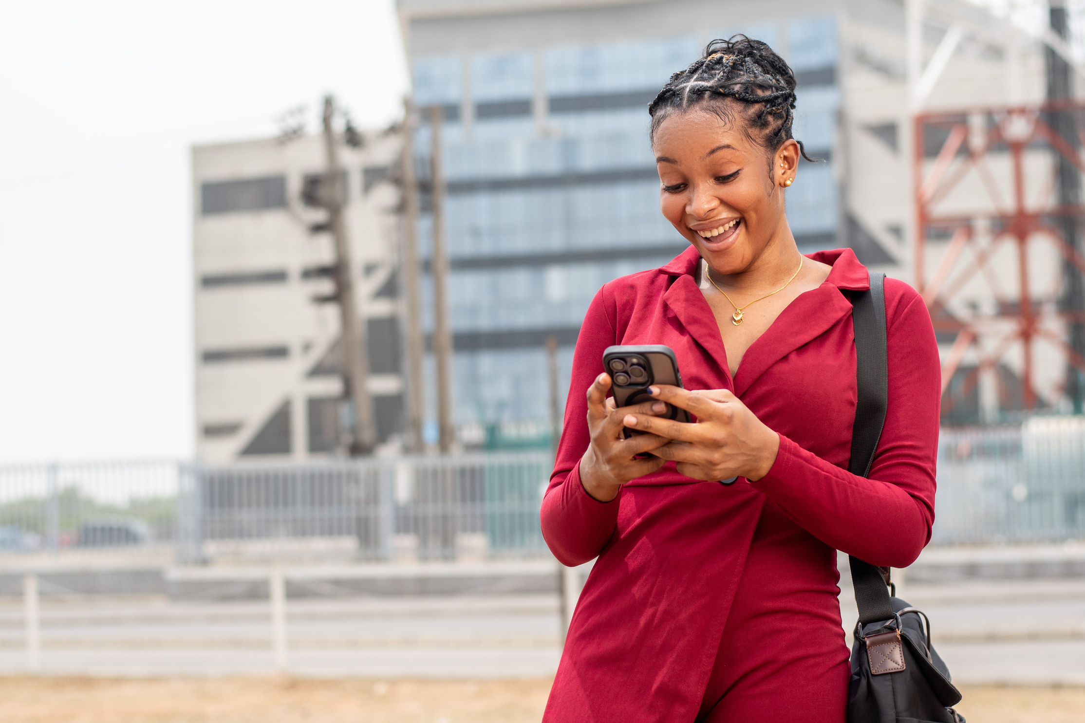 beautiful african lady checking her phone looks surprised